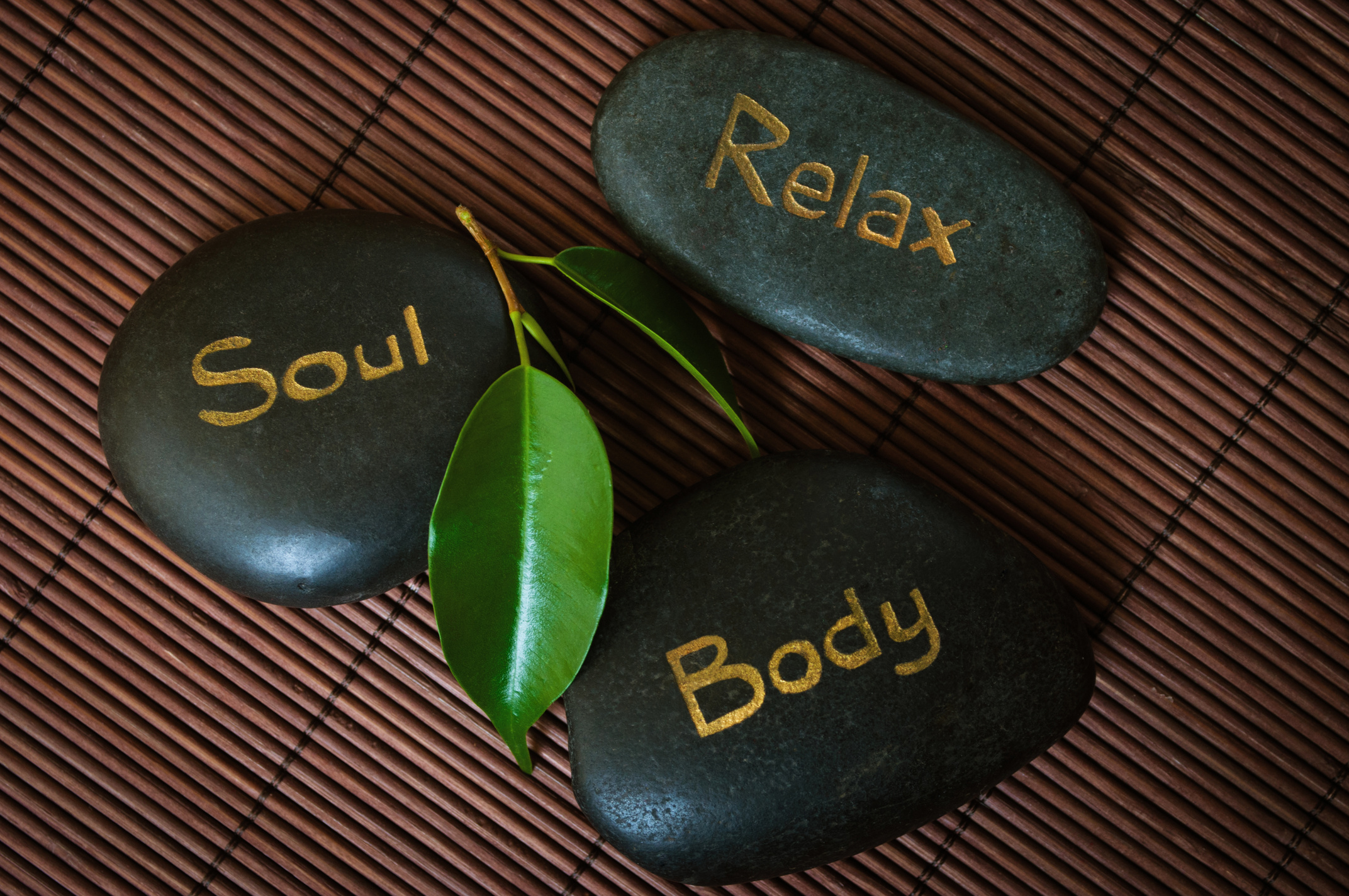 Black Massage Stones with Soul, Relax, and Body Text Flatlay